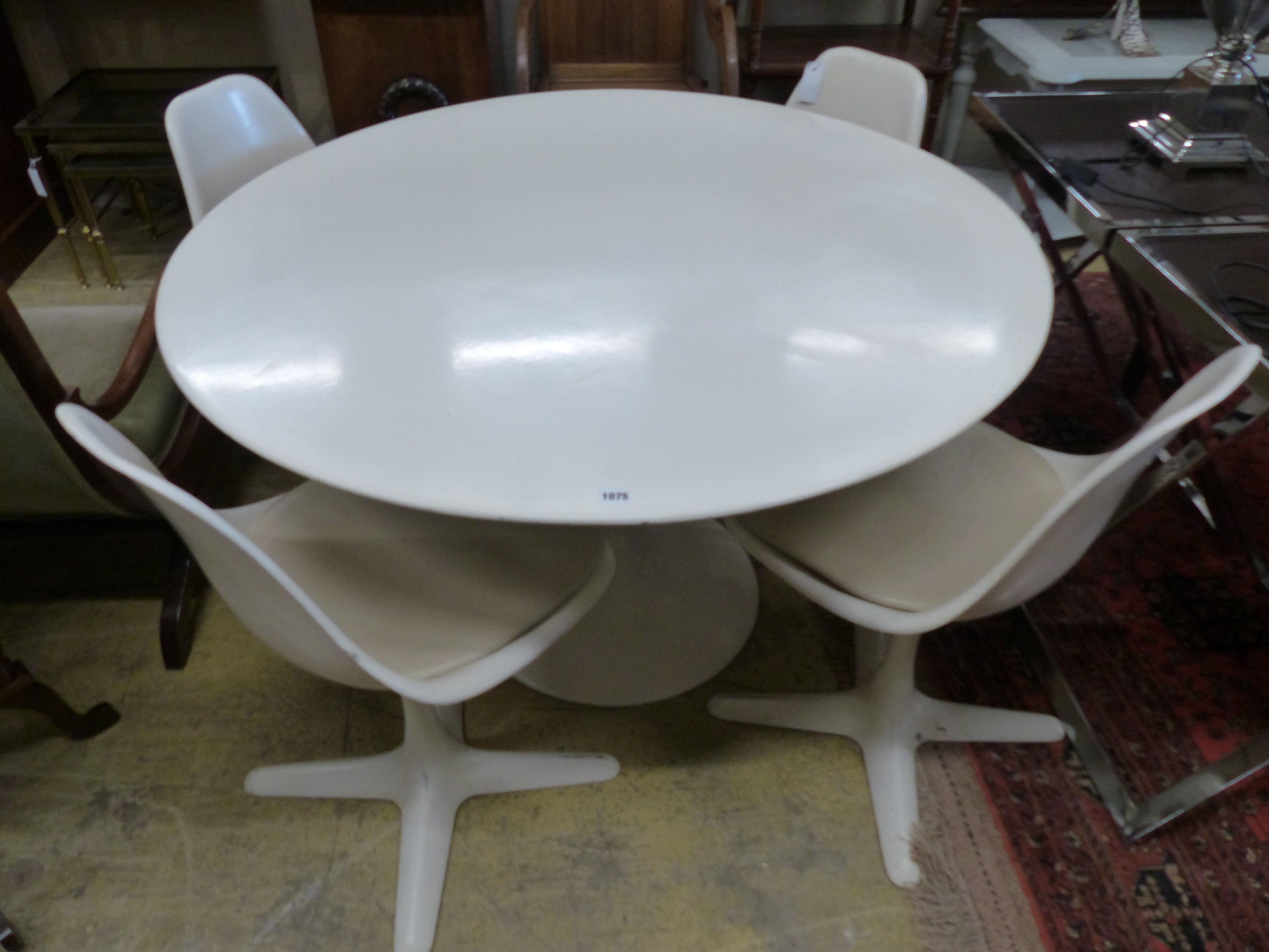 An Arkana tulip table, 120cm diameter, height 74cm and four tulip chairs